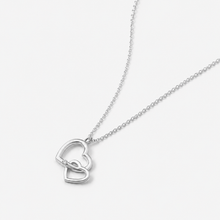 Load image into Gallery viewer, Silver necklace with a heart-shaped pendant on a light gray background