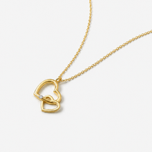 Load image into Gallery viewer, Gold necklace with a heart-shaped pendant on a white background
