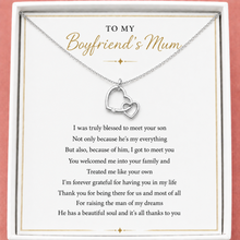 Load image into Gallery viewer, Silver heart-shaped necklace on a card with a message to 'My Boyfriend's Mum' on a pink background
