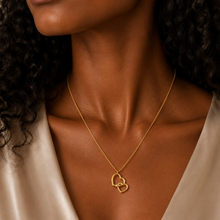 Load image into Gallery viewer, Woman wearing a gold necklace with heart pendants
