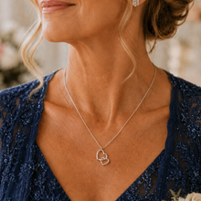 Load image into Gallery viewer, Mother off the bride wearing a silver necklace with heart pendants
